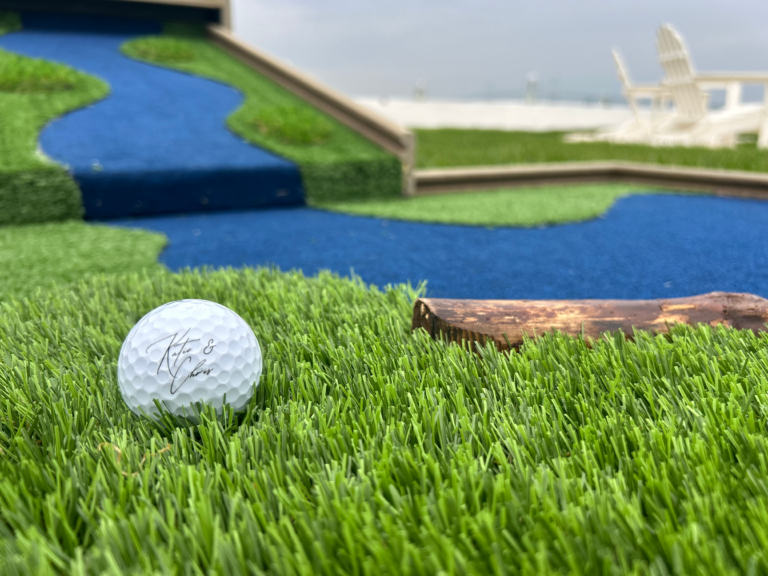 cocktail hour mini golf with custom wedding favor golf ball