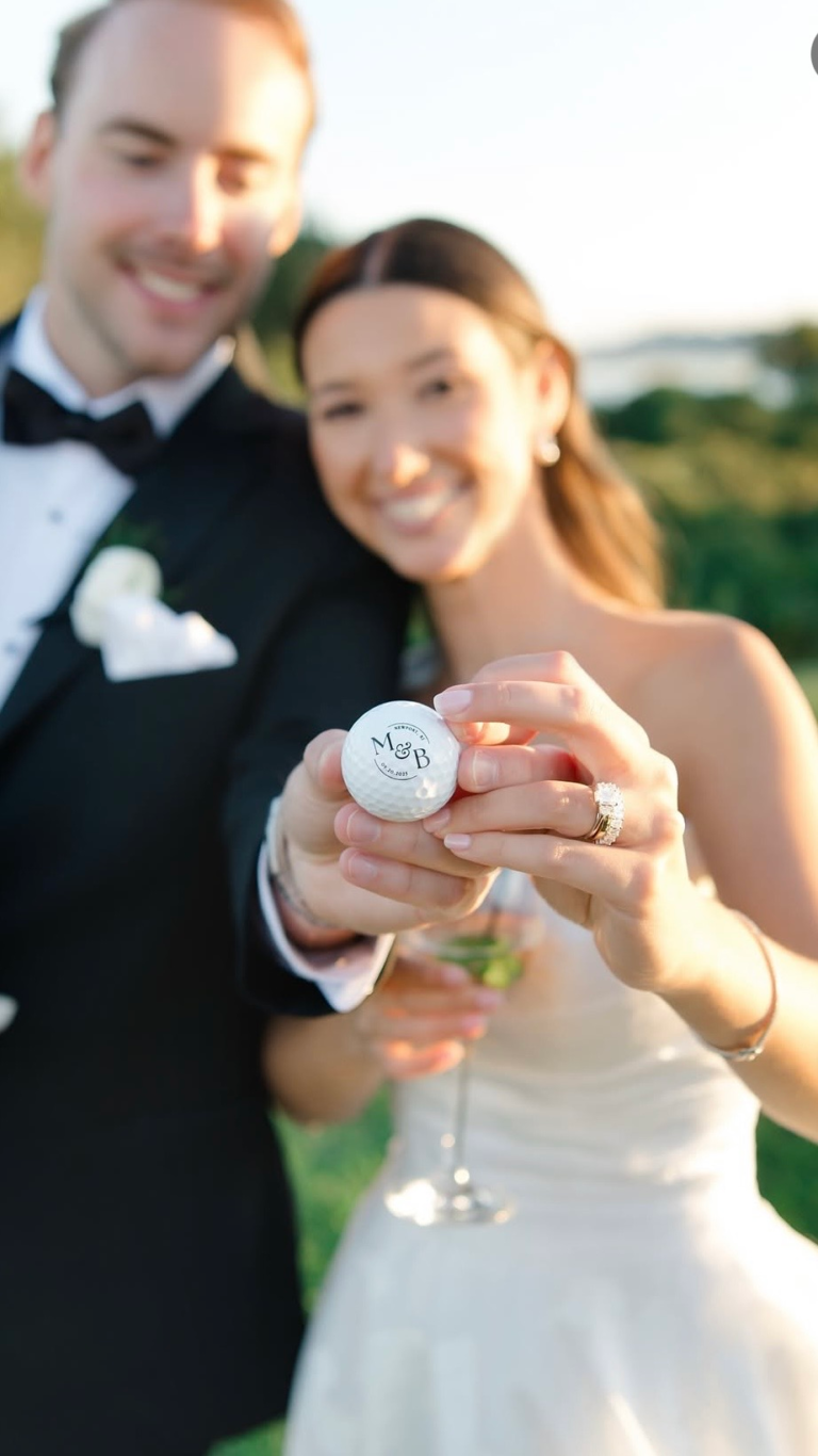 bride and groom holding custom wedding golf ball