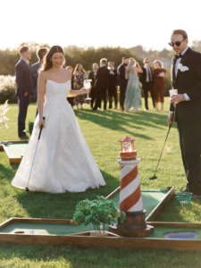 bride and groom mini golfing at cocktail hour